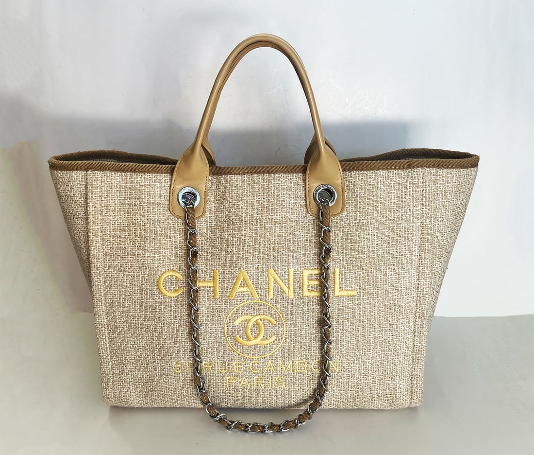 CHANEL CANVAS LARGE DEAUVILLE TOTE BEIGE: PRE-OWNED CHANEL BEIGE CANVAS DEAUVILLE TOP HANDLE SHOPPING TOTE BAG This is an CHANEL Canvas Deauville Tote in Light Beige. This stylish tote is crafted of fine canvas in light beige with a gold prin