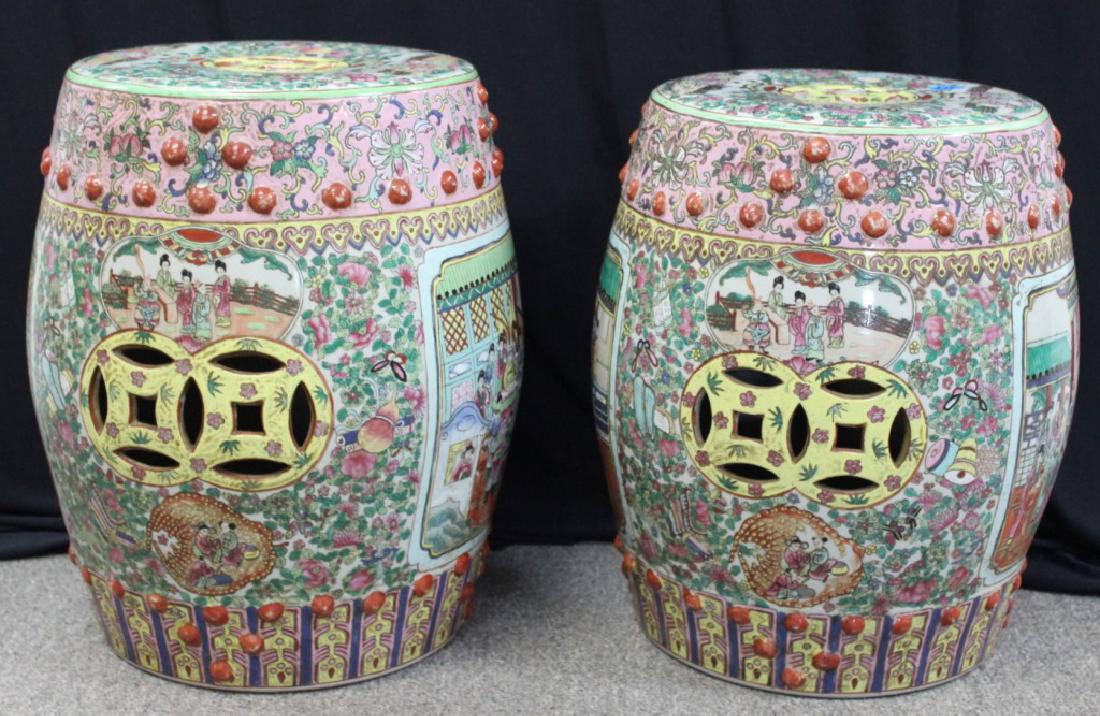 Rose Medallion Porcelain Garden Stools (Pair): Chinese rose medallion garden stools, porcelain, decorated with alternating figures and flowers, carved with hollow on top and sides, red relief buttons around body, 18H x 12 1/2W. From a Flemington, 
