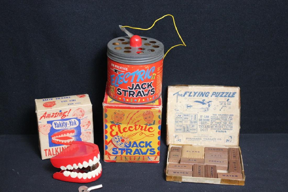 Lot of Vintage Toys: Electric Jack Straws in org. box. Measures 4 in h, 3.5 in w, 3.5 in d. Box has some old tape, but therwise box and toy are good. Yakity -Yak Talking Teeth in original box, working condition w/ key. 3.