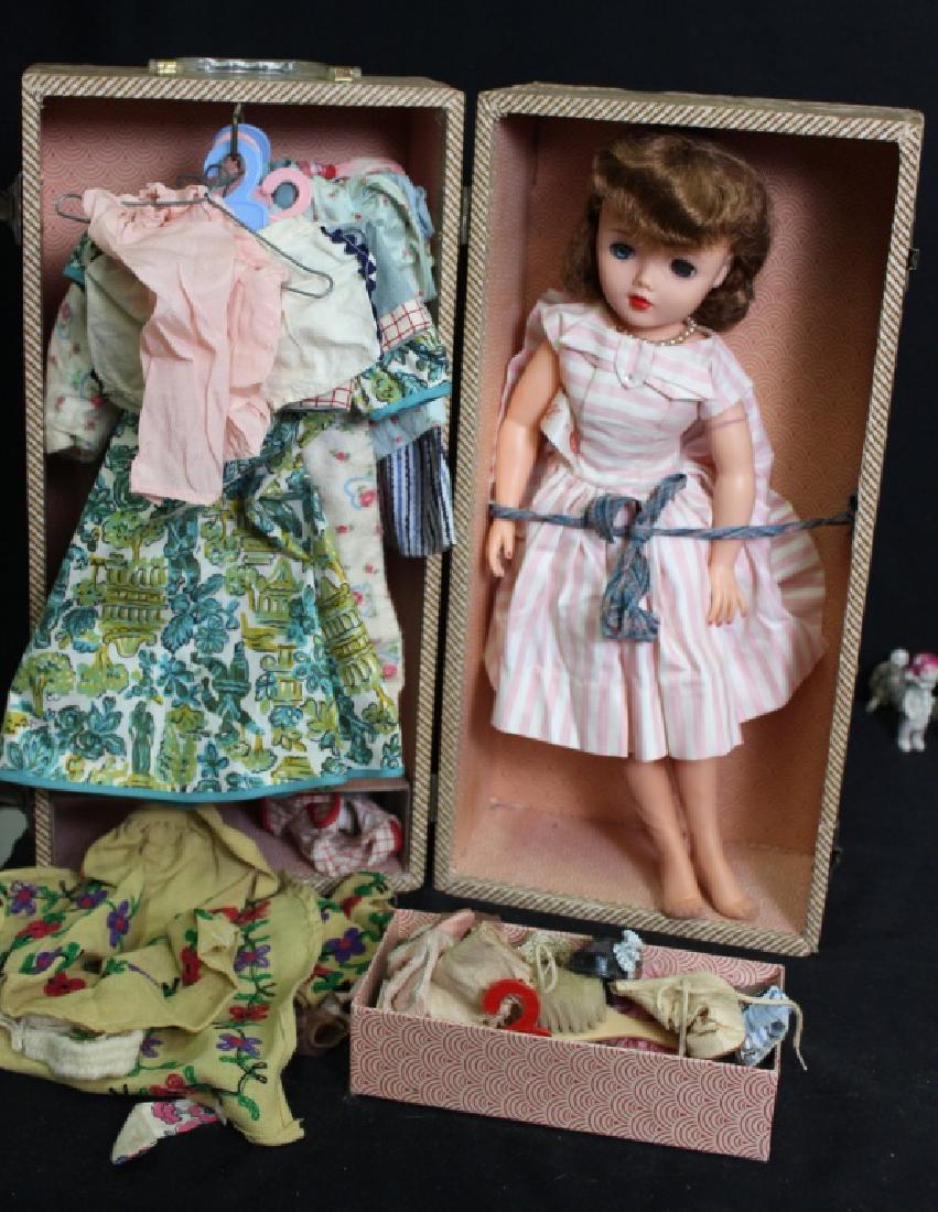 A/O Miss Revlon in Case: 17 in tall alll org, Miss Revlon doll, wearing her tagged dress, stockings, and shoes. She has blonde rooted hair in good condition and blue sleep eyes with full lashes. The case is by Cass and includ