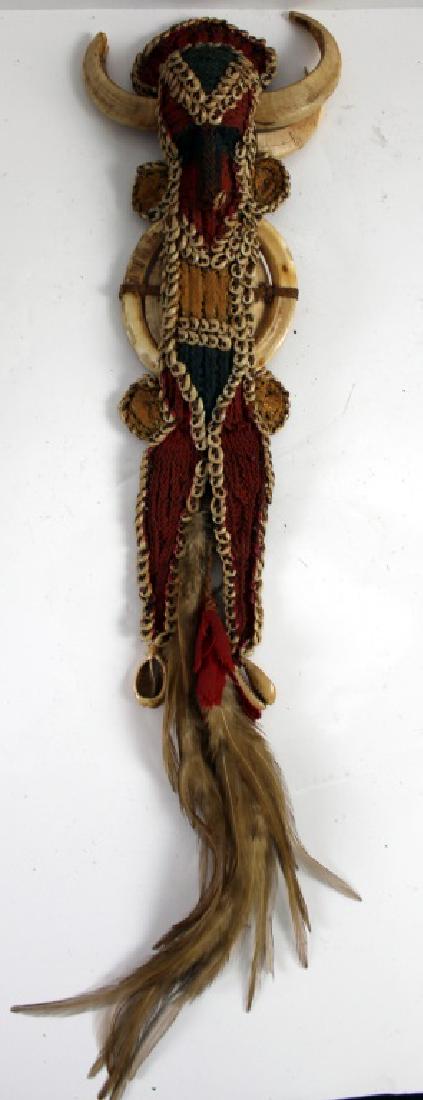 African Warrior Doll and Two Teeth of Animal: 14h x 3w in. Fabric and bone. Included are two teeth from another beast .