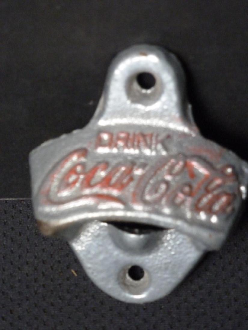 Coca-Cola Bottle Cap Remover, Wall Mounted: 3 h x 2.5 w x 1.25 d inches.