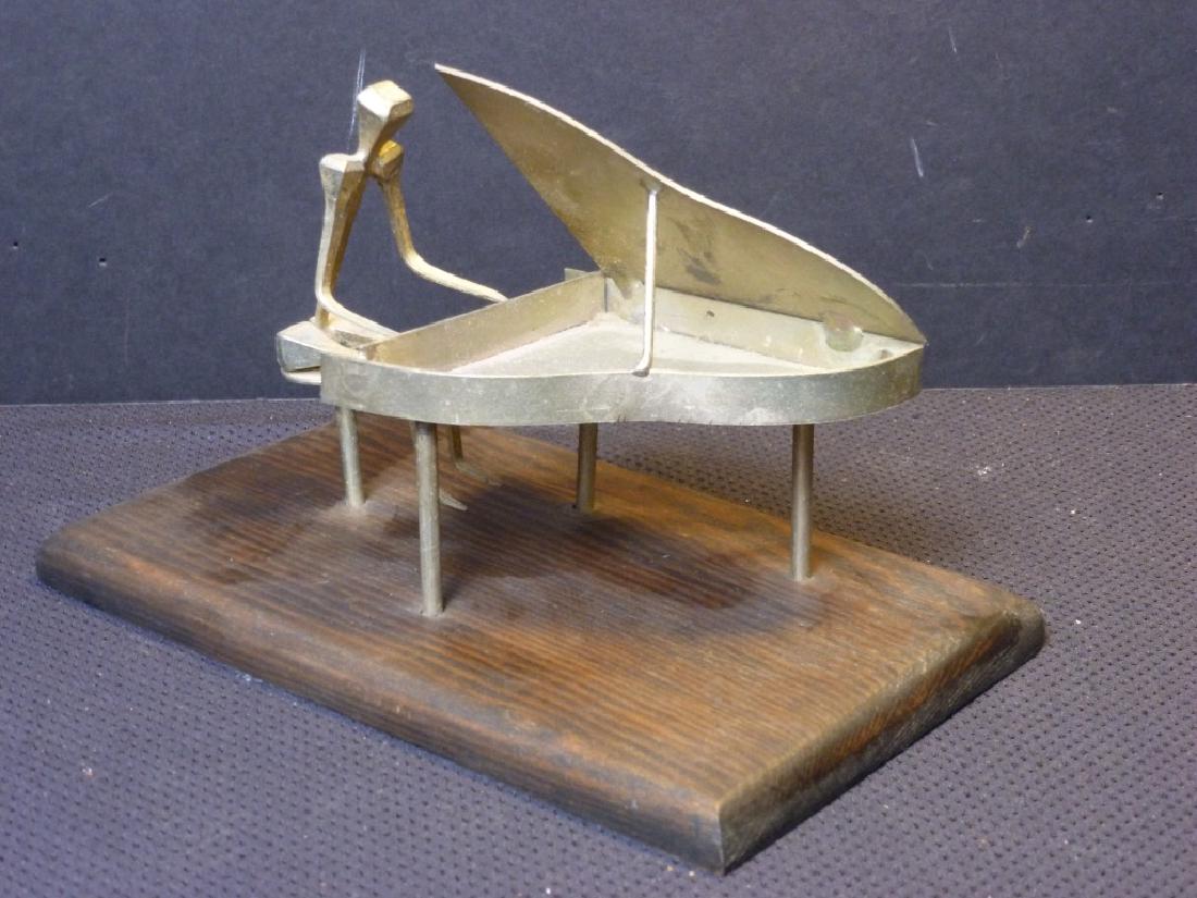 Metal Sculpture of Piano & Pianist: 4.5 h x 7 w x 4.5 d inches.
