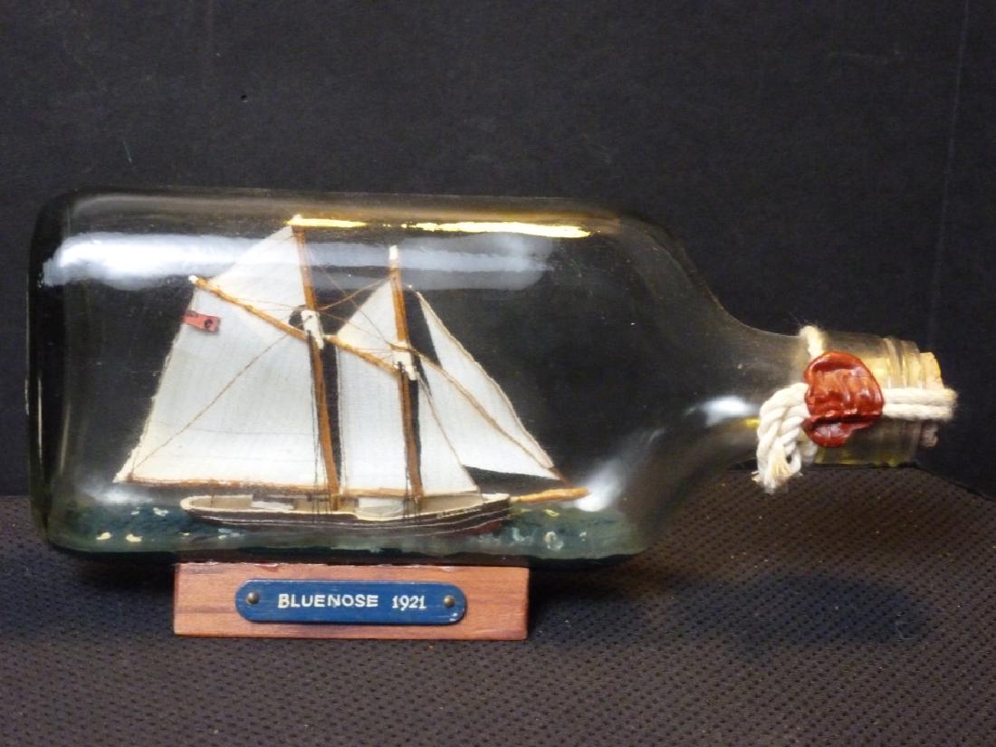 Ship In A Bottle - Bluenose 1921: 4 h x 8 w x 1 d inches.
