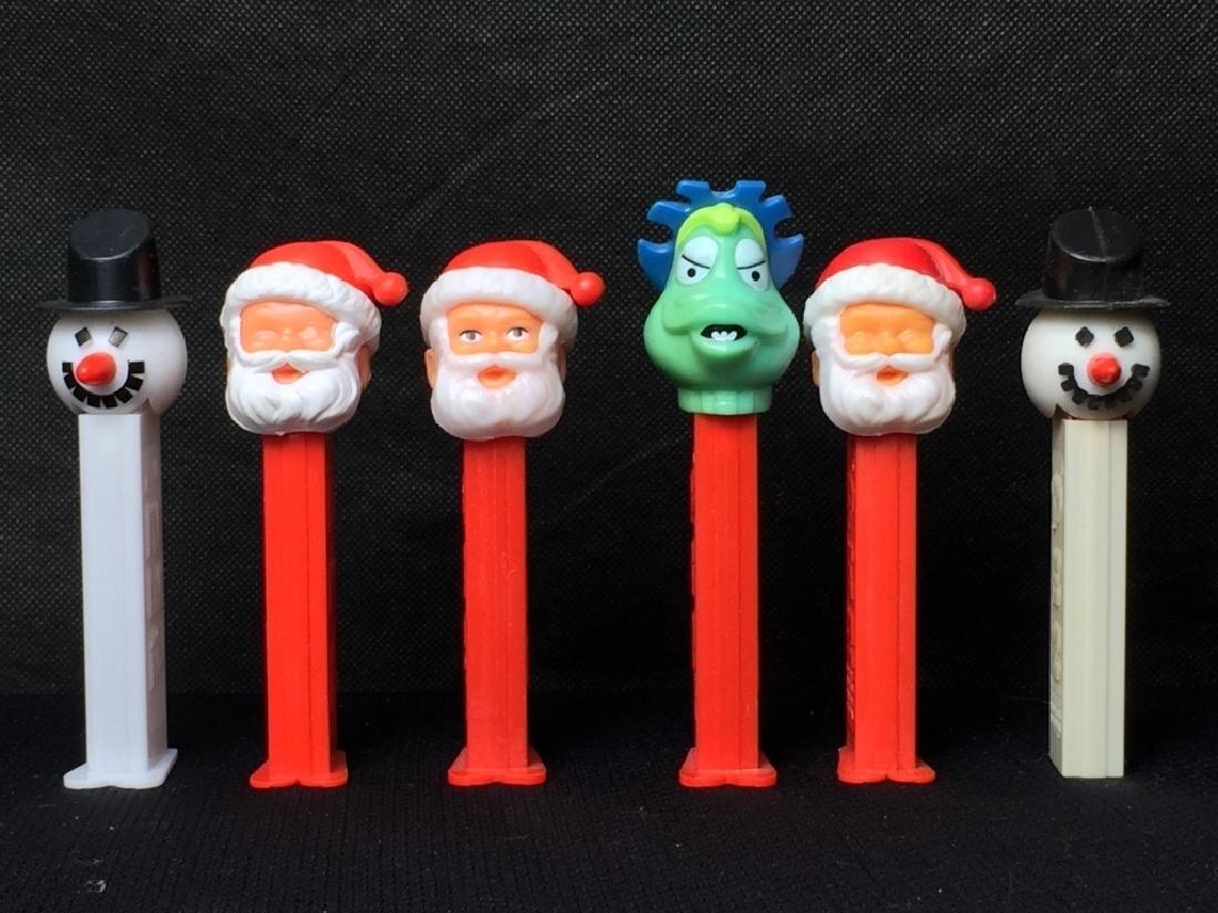 Pez Christmas Lot: 3 Santa, 2 snowmen, and 1 dinosaur. All but snowman on far right have feet. #Pez