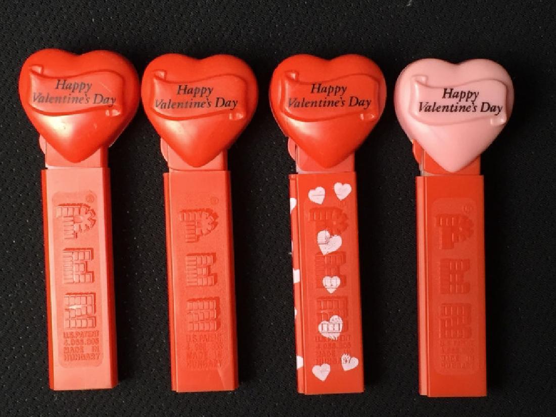 Pez Valentiine: 3 identical red hearts, 1 with pink heart, no feet. #Pez