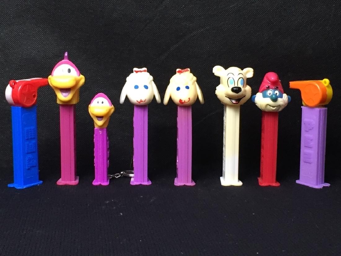 Pez Miscellaneous Lot: (2) whistles, (2) birds, (2) lambs, bear, and Papa Smurf, all with feet. #Pez