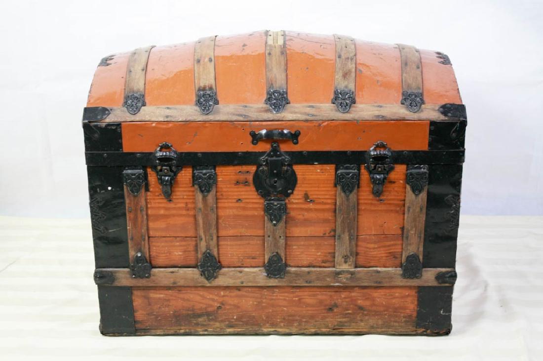 Late 19th C. Camelback Trunk: Pumpkin Brown and black painted hardware. 25.5 H x 34 W x 20 D inches. Paper lining has some cracking and water damage. Wood slats on top have some wood missing. #trunk #steamer #dometop #camelback