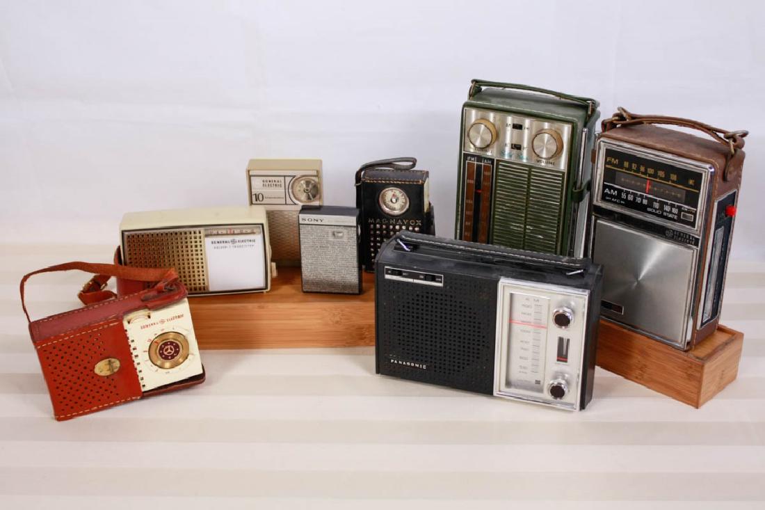 Vintage Portable Radios (8): Panasonic AM Radio, General Electric FM/AM Radio, Tempest AM/FM AC/DC Radio, General Electric AM Radio in cowhide case, Magnovox Transistor, Two General Electric Transistor, Sony Transistor. 8.5 H x 6
