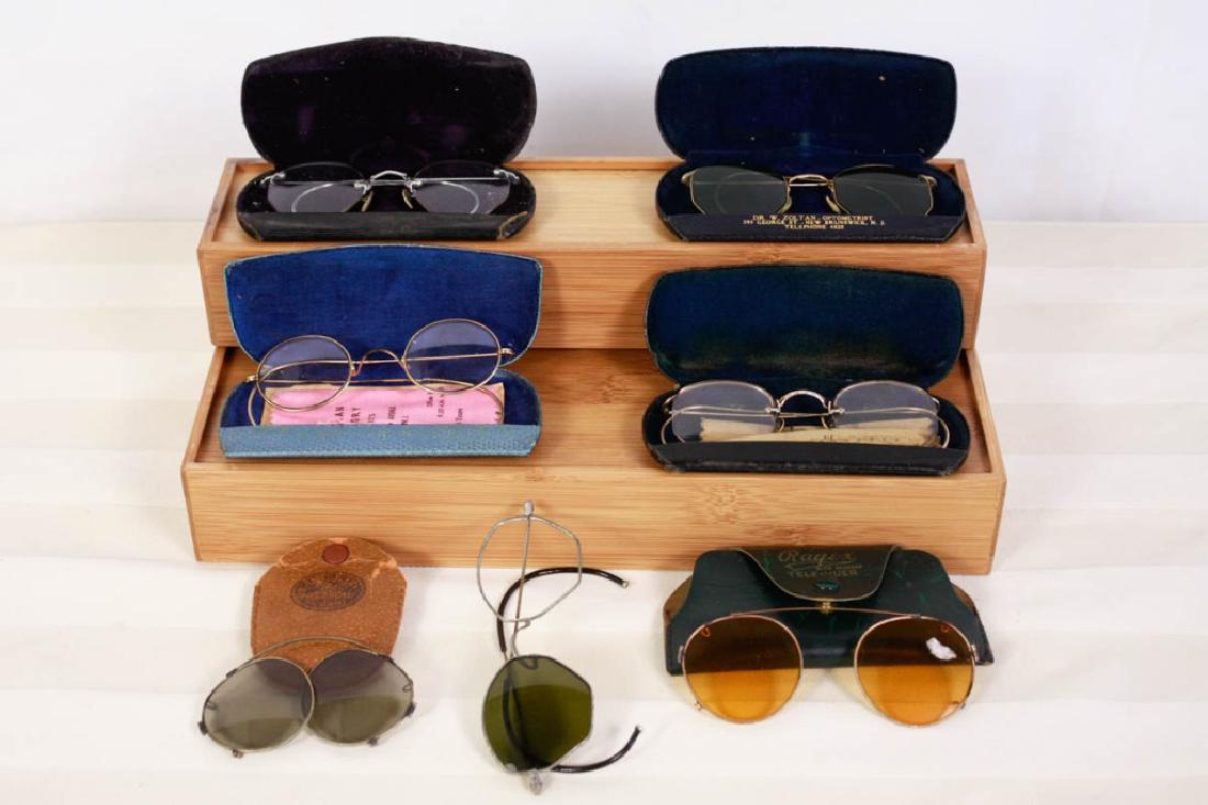 7 Pairs of Vintage & Antique Glasses & Sunglasses: 6 pairs with cases. 1 pair missing lens. Some marked. 1 marked 12K gold, 1 marked 12K gold filled. #vintagesunglasses #antiqueeyeglasses #vintageeyeware #props #vintageglasses