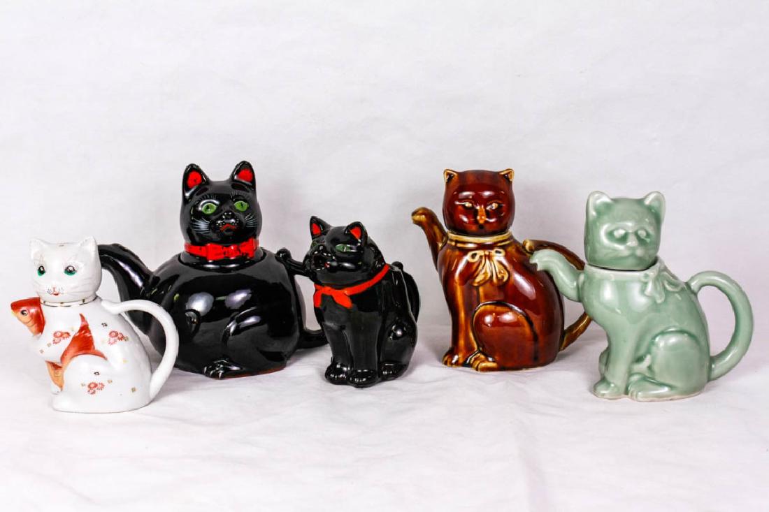 Vintage Cat Teapots & Creamer (5): Including cat with fish teapot, marked made in China, 5.5h inches; 1950s Shafford black cat redware "Halloween" teapot, marked Shafford Japan R.D. 1951, 7h inches; 1950s Shafford black cat "Halloween"