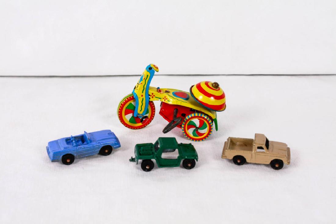 Vintage Wind Up Linemar Tricycle & Metal Toy Cars: Bike marked Linemar Walt Disney Productions LM-257, Made in Japan, Circa 1950s, 2.5h x 4d inches. (2) cars marked TOOTSIETOY USA, 2 - 2.25 inches long. (1) car marked Aja Runabout, 2.25 inches long. W