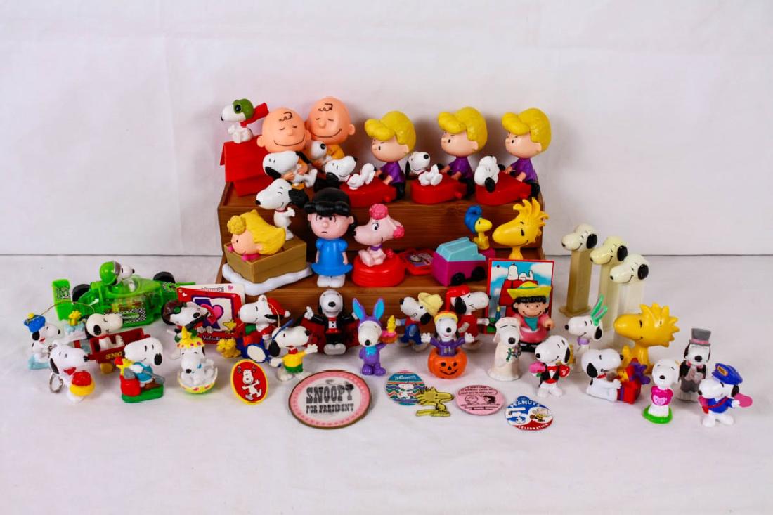Collection of Snoopy & Peanuts Figurines: 45 pieces including (11) McDonalds toys, (3) Pez dispensers, Tart candy race car, (4) tags, (2) pins, plastic ring, key chain, (2) ornaments, Woodstock magnet, Lucy figure, Woodstock figure, (17) Snoo