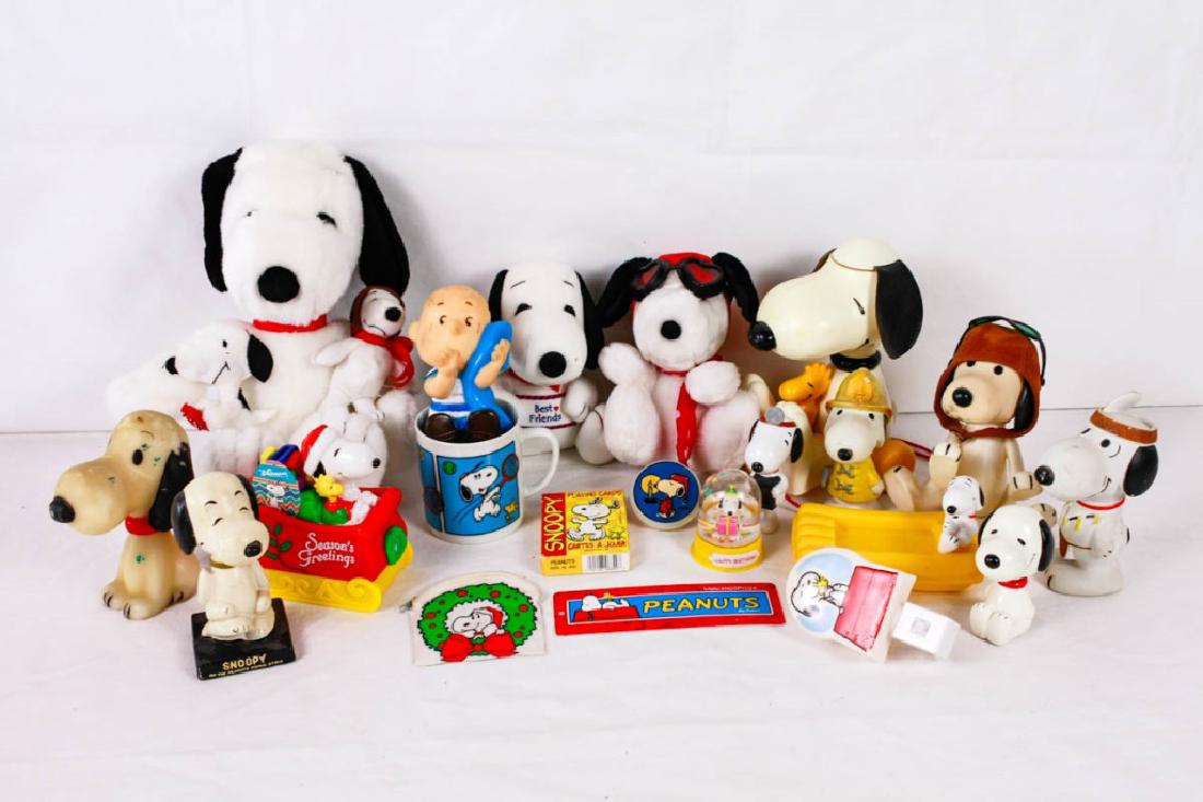 Collection of Snoopy Memorabilia: 24 pieces including candle, 2 bobble heads, string pull toy, 5 plush, 2 nightlights, snow globe, soap dish, 2 tags from toys, playing cards, coin purse, 2 squeak toys, Burger King toy, bank, mug, Linu