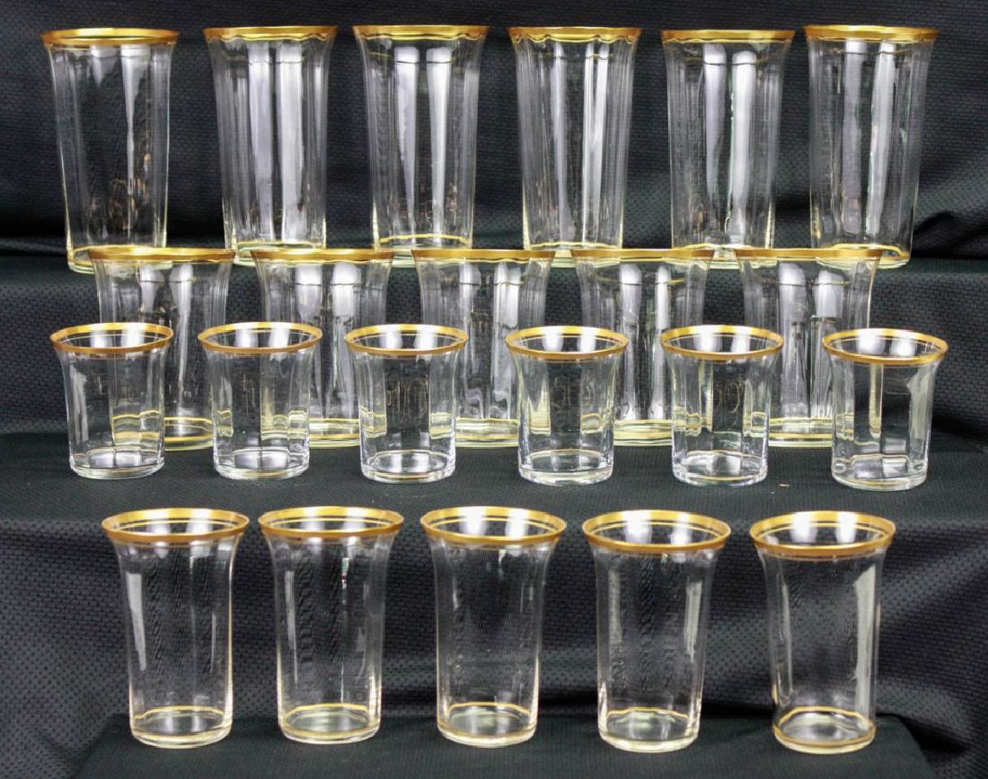Gilt Rimmed Glassware, 22 Pieces: 22 pieces total including (6) water glasses, 5h inches; 5) tumblers, 4h inches; (5) narrow glasses, 3.75h inches; (6) shot glasses, 2.5h inches. #Glassware #VintageGlass