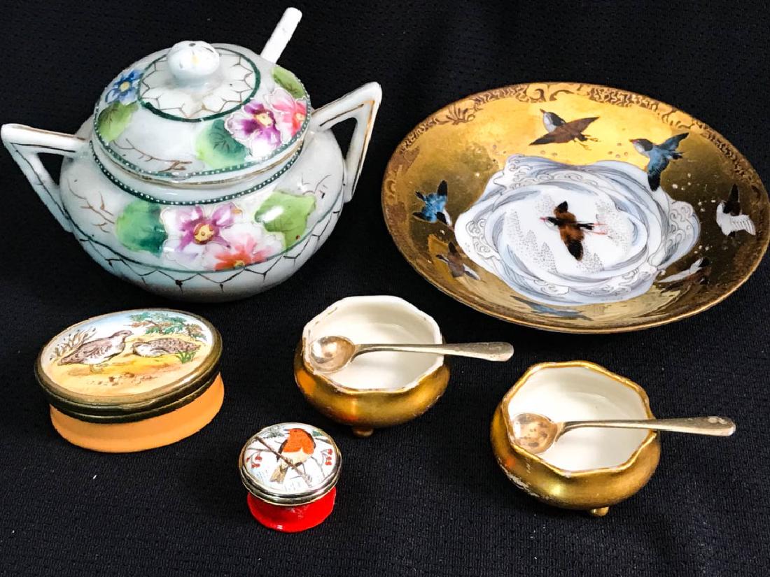 Assortment of Serving Pieces: 6 pieces total including plate (4.5w inches); lidded bowl with porcelain spoon (3h x 4.25w inches); pill box, (1h x 1.75d inches); orange pill box, (.5h x .5w inches); pair of salts (.75h x 1.5w inche