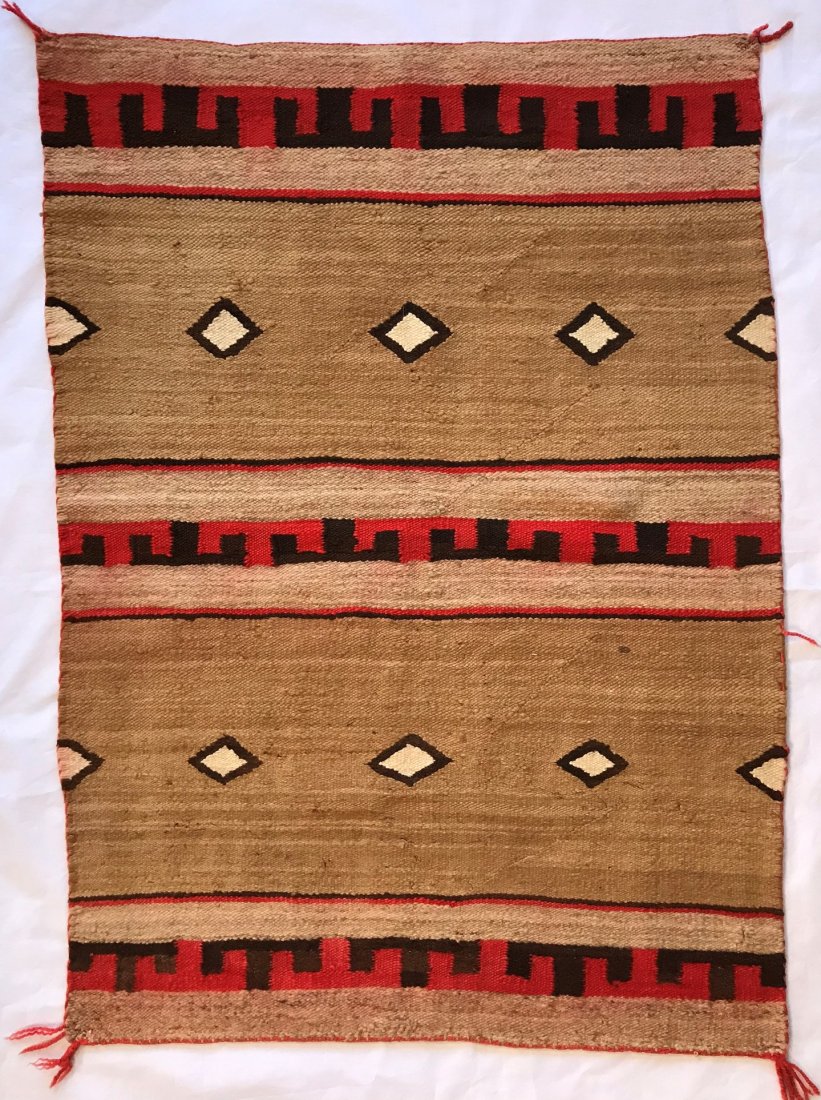 Navajo Rug: Beige Background, Horizontal Design with red & black and White Diamonds. Some bleeding of red dye. 51h x 37w inches.