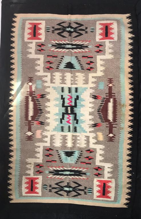 Navajo Warrior Rug: Black Background with Turquoise, Red, Pink, Rust & Black Colored Designs Some Stains, see photos. 87h x 54w inches.