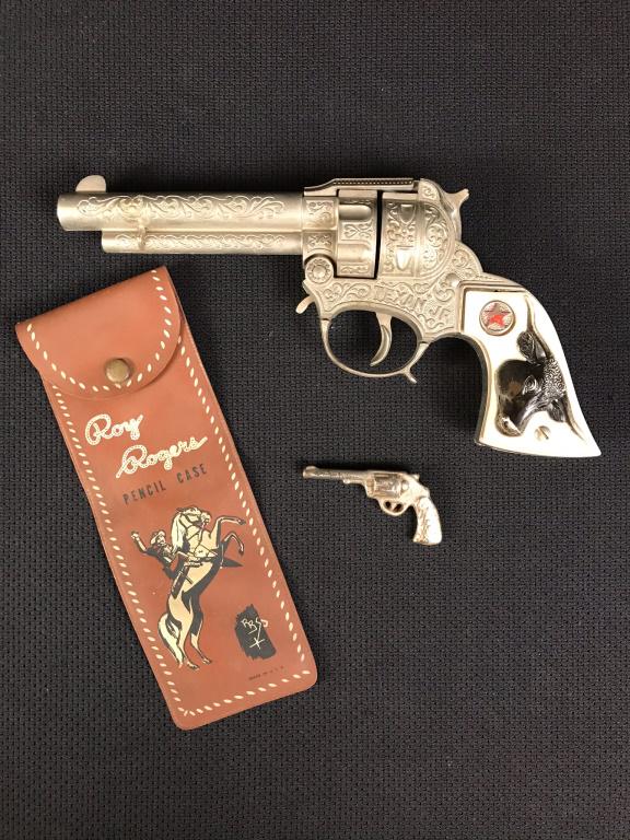 Hubley Texan Jr., Roy Rogers Pencil Case: Hubley Texan Jr. cap gun needs work for trigger to work properly - 4.5h x 9 long inches. Roy Rogers Pencil Case 7.5h x 2.75w inches. Miniature toy gun is 1.25h x 2.5w inches.