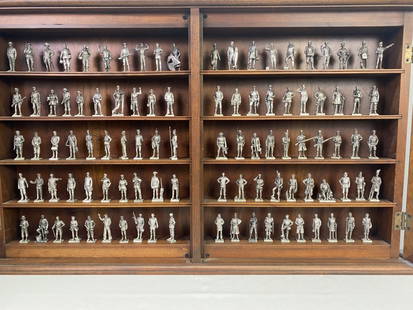 American Military Sculpture Collection & Case: Wood case with glass doors. 100 military men made of pewter. From 1977. 21.25"h x 35"w. 3 lbs. THIS LOT MUST BE PICKED UP OR ARRANGE FOR SHIPPER