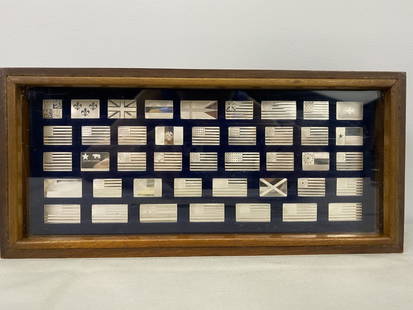 Sterling Ingots Great Flags of America: Franklin Mint Set of 42 Sterling Silver Ingots with Certificate of Authenticity. Per internet research the total weight of Sterling (.925) silver in the set is 6.9 oz. 5.5'h x 12"w x 1.75"d.