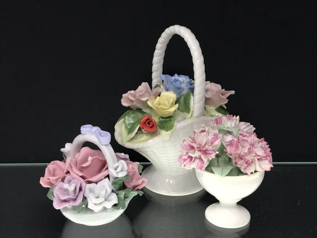 Porcelain Flower Baskets: Porcelain Flower Baskets. Carnation, Crown England Bone China. "August" Royal Crown, England (high handled basket). Short basket, no markings. 2.5"h - 4.5"h x 2.5"w - 4"w. 13oz.