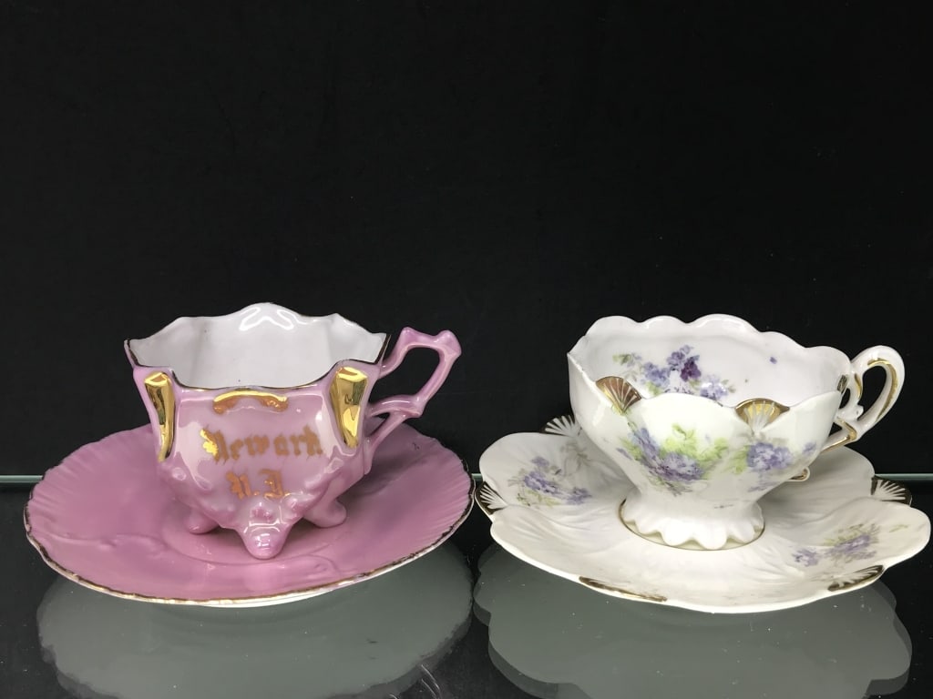 Miniature Tea Cups - One Marked Newark, NJ: Miniature tea cups and saucers. Pink souvenir cup marked "Newark, NJ" the other white with blue flowers. 2-2.5"h. 5 oz.