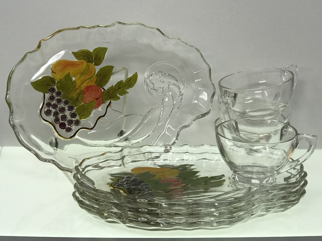 Glass Luncheon Plates with Tea Cups, Set of 4: Glass luncheon plates with tea cups, set of 4. Hand Painted from on underside. 10"w x 7.25"d x 3/4"h. Cups 2.25"h x 4.25"w at handle. 4lbs. 1oz.