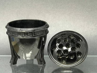 Black Amethyst Glass Planter & Flower Frog 1930's: LE Smith Black Amethyst Glass Art Deco 3-Footed planter with Greek Key and flower design. 4.25"hx 4 5/8"d. Black Amethyst 16 hole flower also made by L.E. Smith. 1"h x 4.25"d. 1lb. 12oz.