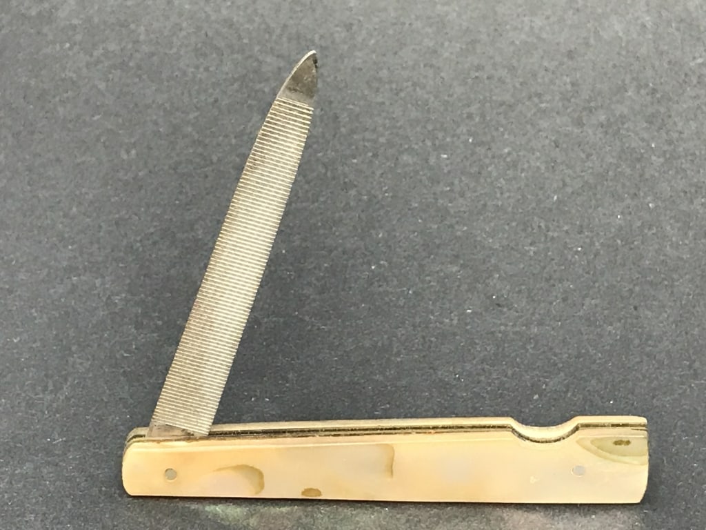 Folding Mother of Pearl Nail File: Folding Mother of Pearl Nail File. 5"long. 4 oz.