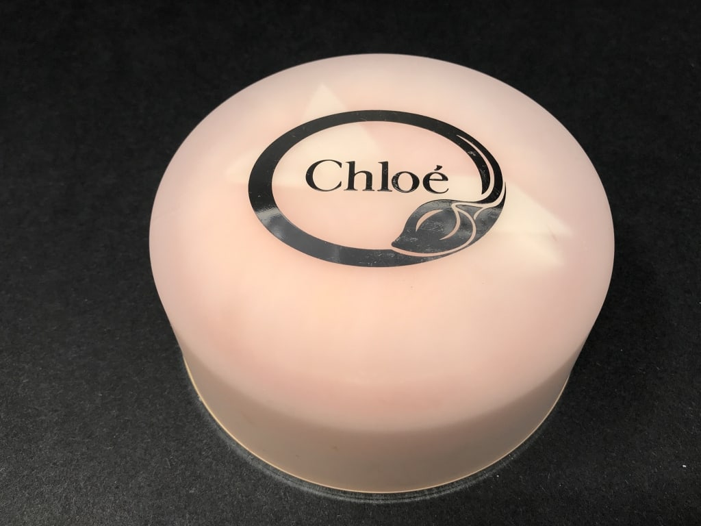 Chloe Perfumed Dusting Powder: Chloe Perfumed Dusting Powder 2.6 oz. Powder sealed, never opened, unused. 4.5"d x 1.75"h. 5.9 oz. total weight.