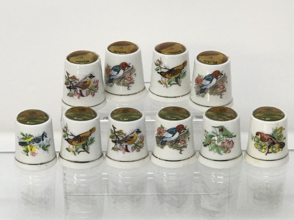 10 Ceramic Thimbles: 10 Ceramic Thimbles. 4 Tahquamenon Falls Michigan and 6 Daytona 500. 4 oz. 1"h x .75"d.