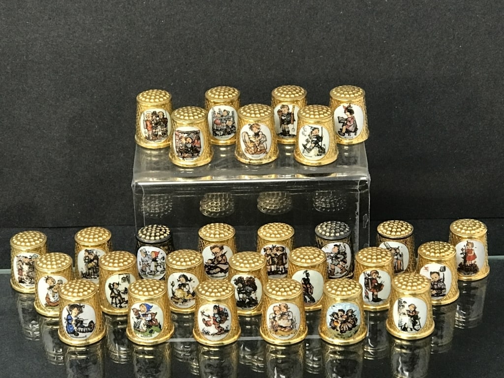 28 Hummel Thimbles, W. Germany: 28 Hummel Thimbles, W. Germany. 7/8"h each, 9.5 oz. total weight. See photos 2 thimbles have significant loss of gold tone.