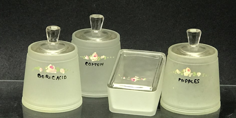 Nursery Containers Hand-Painted 4 Pieces: Nursery containers hand-painted. Hazel Atlas, 1940-50's. Cotton ball, Boric Acid, and Nipple Jars 4.25"h x 3.25"d with lids. Soap dish 1.5"h x 3.75"w x 2.75"d. 2lbs. 6oz.