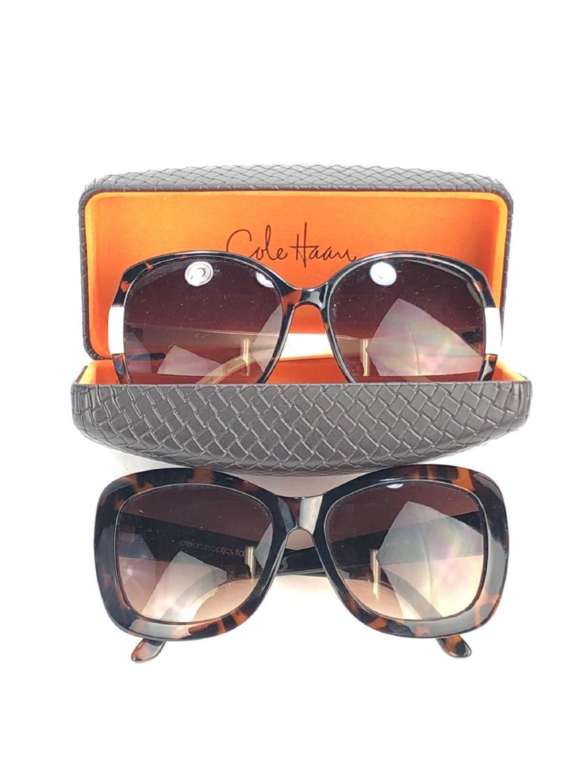 Pair of Designer Sunglasses: Pair of Sunglasses by Cole Haan (C8030) and Halston Heritage (H104.) Dark Tortoiseshell with Cream Details on the Cole Haan Pair. Cole Haan Case with Basketweave Design Included. Halston Heritage Widt