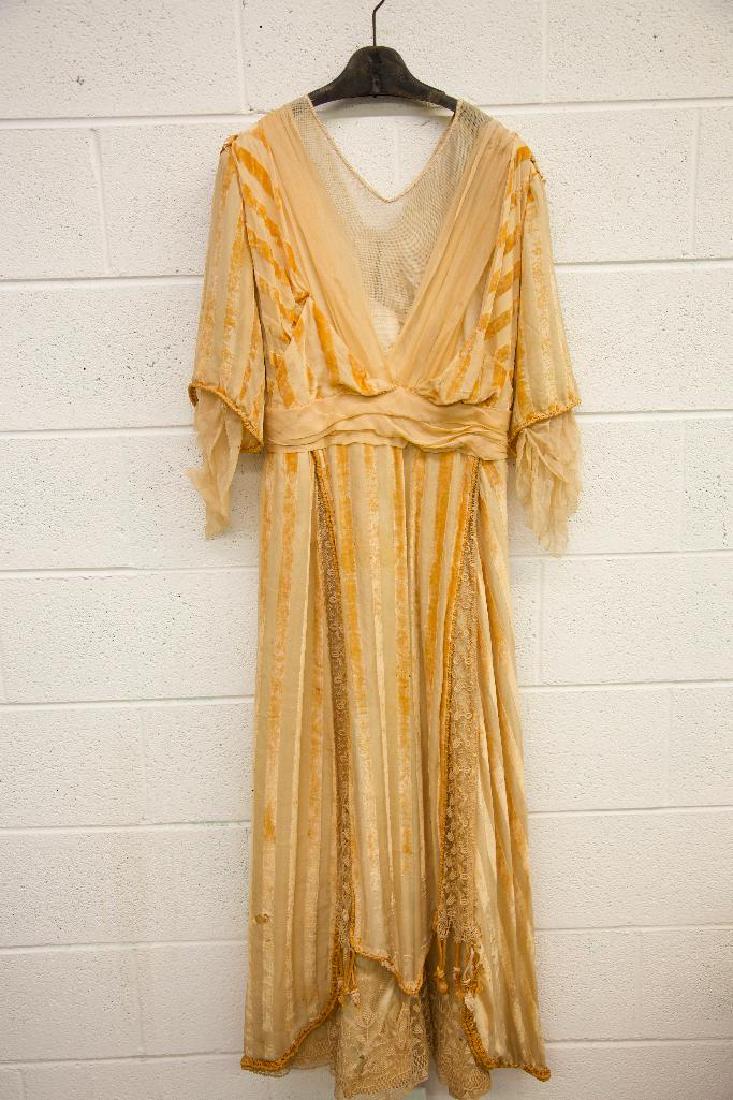 Renaissance Style Clothing: Various sizes. One renaissance style dress featuring crystal beading, lace, and velvet trim with signs of wear and some holes worn through. Silk slip with lace trim. Men's doublet with lace cuffs and 