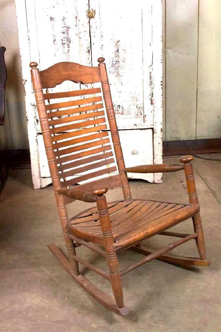 Antique Arts and Crafts Style Rocking Chair: 22 x 32 x 44 Wood. Antique arts and crafts style rocking chair with slatted back. In like found condition.