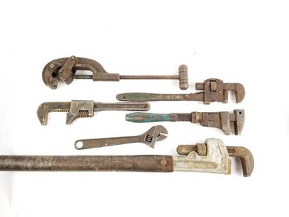 Lot of Antique Heavy Pipe Fitting Tools: 28.5lbs, Mixed metals Five vintage heavy pipe wrenches with one heavy pipe cutting tool. Tools of varying age and condition. One wrench includes a rustic extension.