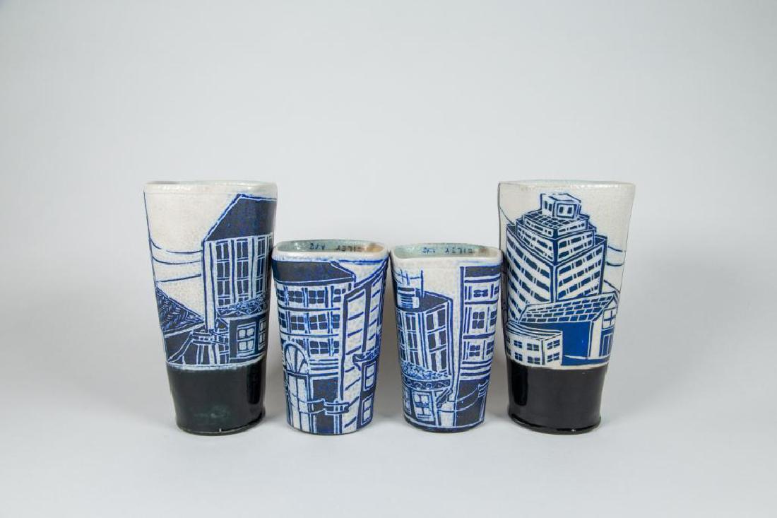 Julia Galloway Childhood Home Tumblers Set of 4: Julia Galloway Childhood Home Tumblers Set of 4. Four wheel thrown and soda fired tumblers with blue city skyline design. "Wiley Ave" signed on the interior. Signature on bottom exterior. Ribbing and 