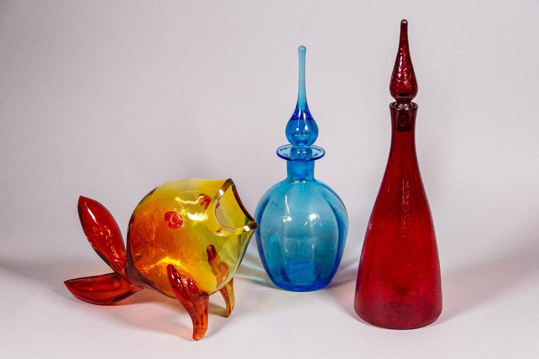 Set of Three (3) Blenko Glass Decanters and Fish: Set of three (3) Blenko glass vase. Includes: One (1) Blue decanter with stopper designed by Joel Myers. CONDITION: Good. Refer to photos for condition. MEASUREMENTS: H 14in. x DM 5in. One (1) Tangeri