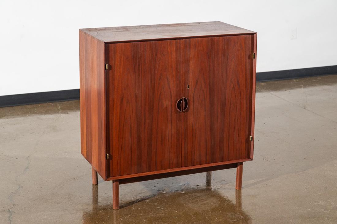 Peter Hvidt Double Door Danish Teak Cabinet: Peter Hvidt Double Door Danish Teak Mid Century Modern Cabinet.The cabinet has exposed dovetailed top, round legs with exposed brass hinges and brass keyhole. CREATOR: Peter Hvidt. PLACE OF ORIGIN: De