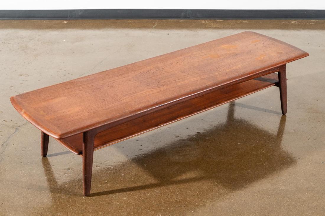 Danish Mid-Century Modern Teakwood Coffee Table: Danish mid-century modern teakwood coffee table, c. 1950s, the long top over lower shelf, raised on four supports. CREATOR: Unknown. PLACE OF ORIGIN: Possibly Denmark. PERIOD: Mid 1950's-1960's.