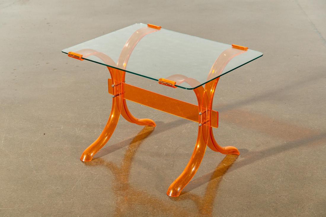 Attr. Paul Laszlo Orange Lucite and Glass Table: Attr. Paul Laszlo Orange Lucite and Glass Table. CONDITION: Good. Minor surface scratches on glass and acrylic. Refer to photos for condition. MEASUREMENTS: H 19.5in x W 28in. x D 20in