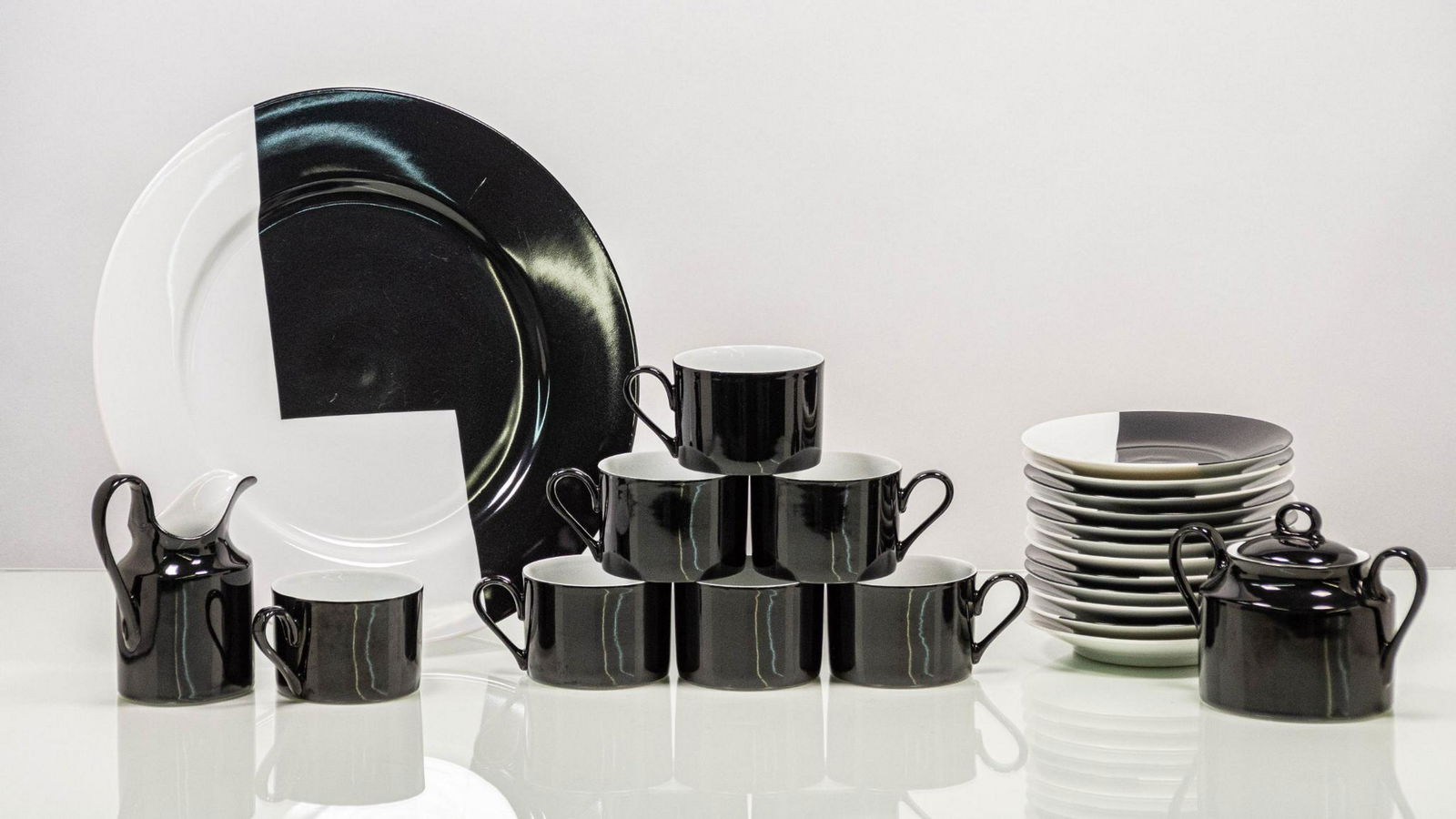 Larry Laslo for Mikasa "Step Black White" Fine China: Mikasa fine china tea set. MAKER: Larry Laslo for Mikasa. TITLE: "Step Black and White". CONDITION: Very good, plate has wear to edges; incomplete set. DIMENSIONS: seven (7) cups H 2.5” x DM 3.5
