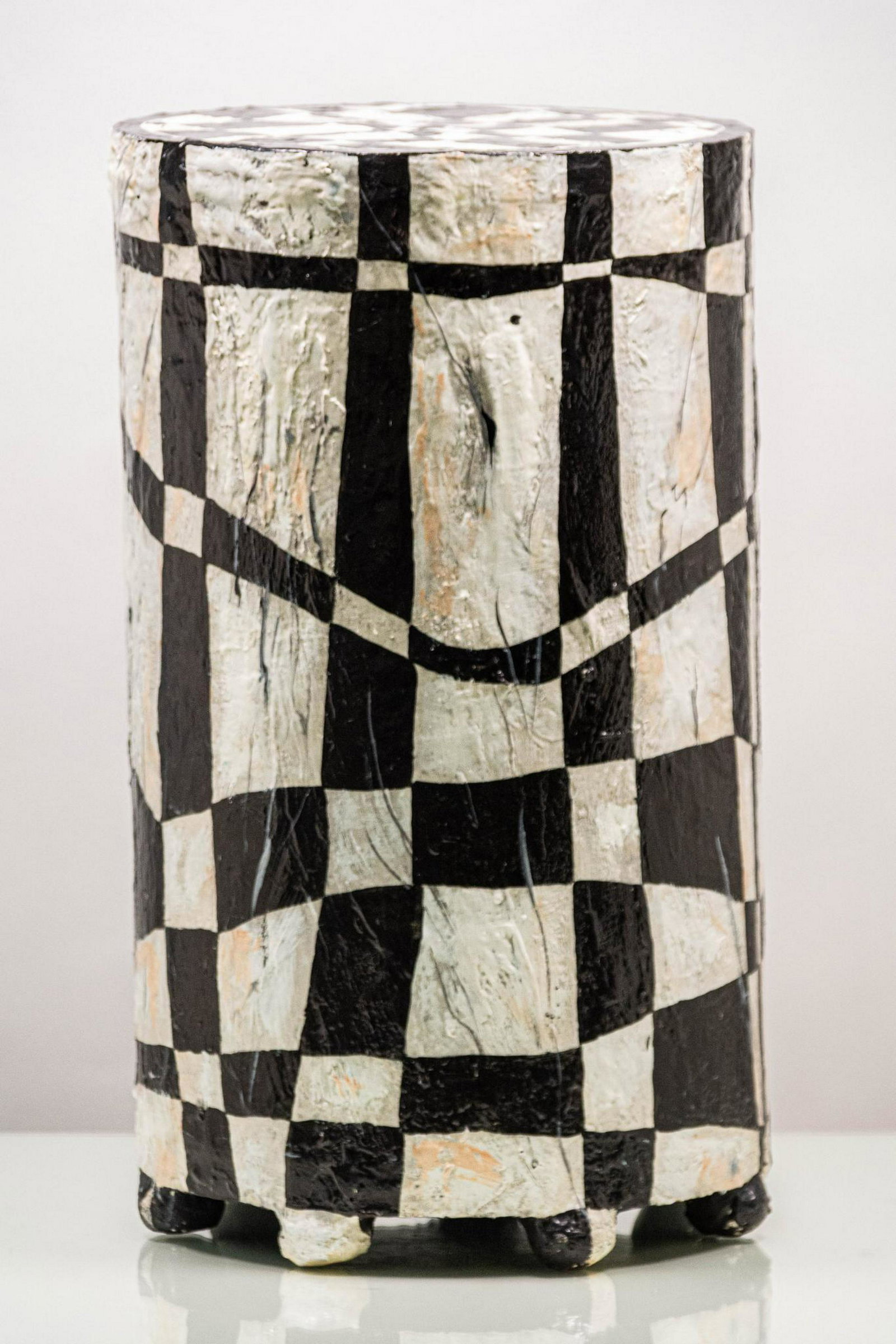 Joyce Miller 1988 Memphis Style Black and White: Cylindrical occasional table, painted with a black, white, grey, and peach colored Memphis style design; textured, with 7 small round feet. Signed and dated by the artist Â© 88 ARTIST: Joyce Miller 