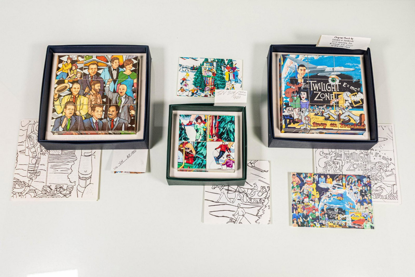 Set of Four (4) Lambert & Samborski Original Puzzles: Set of three (3) original puzzles by Lambert & Samborski in boxes, each titled and numbered "Winter Sports" 304/900, "Years Like Hours" AP/350, "Keep on Dancing" 58/500 ARTIST: Jeff Samborski CONDITIO