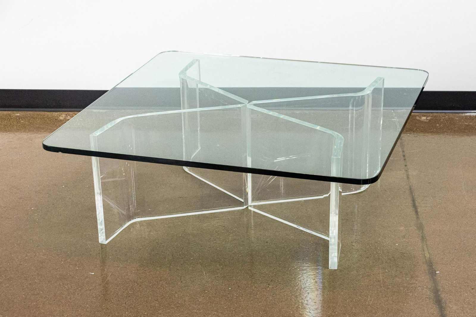 Glass and Acrylic Coffee Table: Square glass-topped coffee table with four customizable acrylic supports. CONDITION: Very good, moderate scuffs and scratches to acrylic bases. DIMENSIONS: H 15.5" x W 42" x D 42"; 3/4" thick glass to