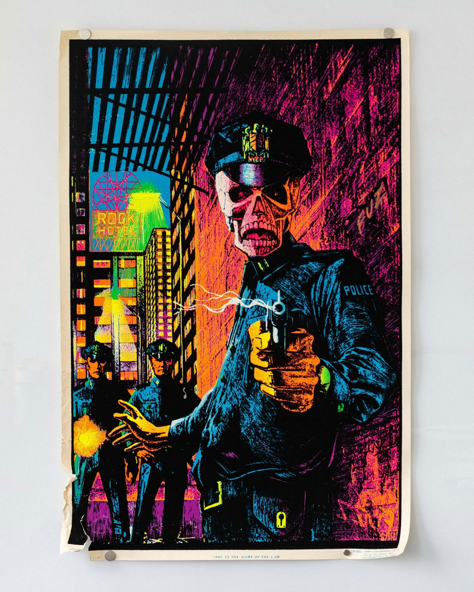 "In the Name of the Law" Vintage 1980s Blacklight: Blacklight poster with a graphic of a three cops in an alley, one of them has a skeleton face and holding a smoking gun. Â© 1982 Funky Enterprises. Inc. DIMENSIONS: 35" x 23"
