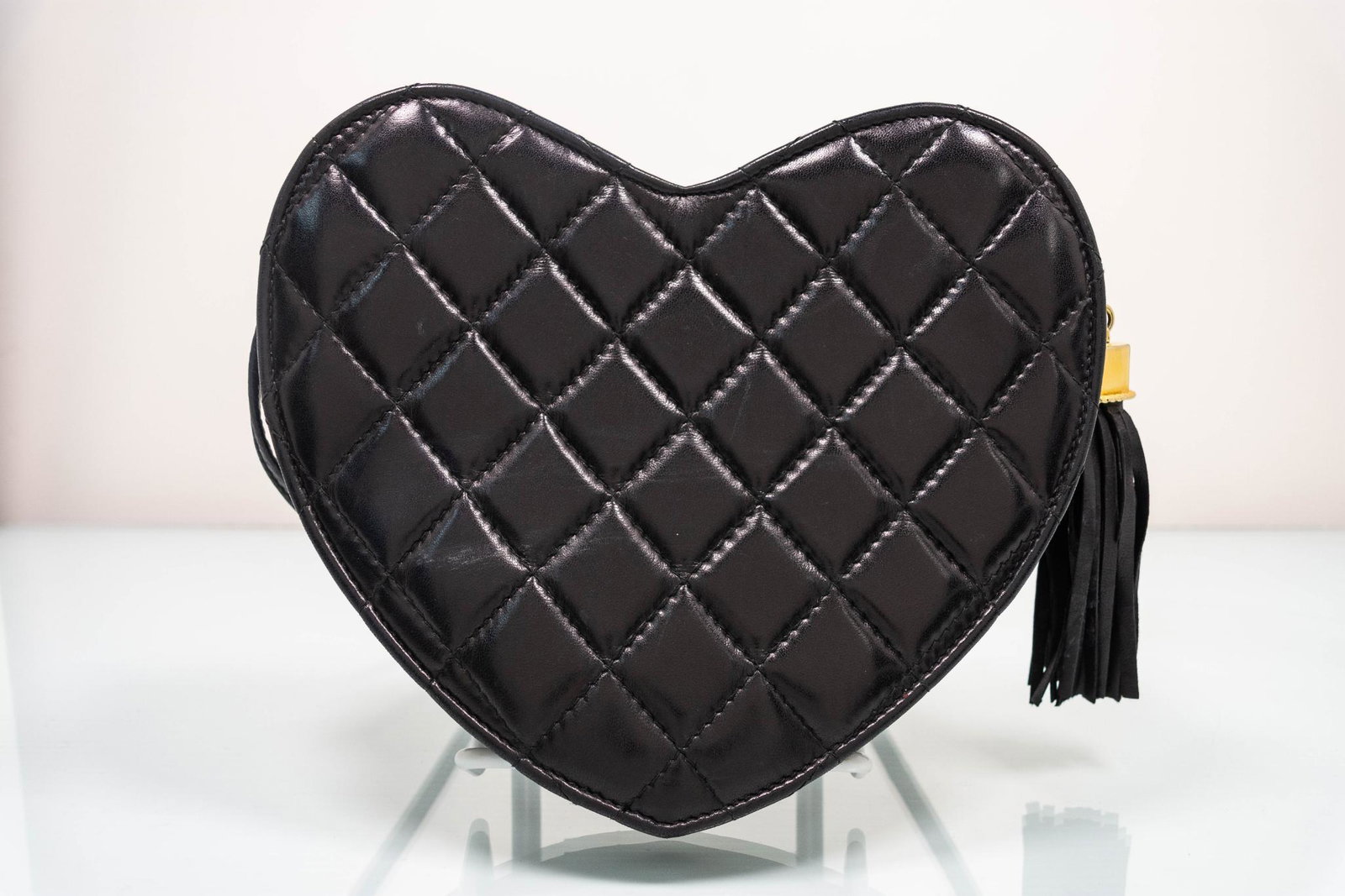 Ermine of Beverly Hills Heart-Shaped Quilted Black: Ermine of Beverly Hills Heart-Shaped Patchwork Black Leather Crossbody Handbag with a tassel with gold colored accent on a zipper closure. MEASUREMENTS: 8" x 8.5" x 2".
