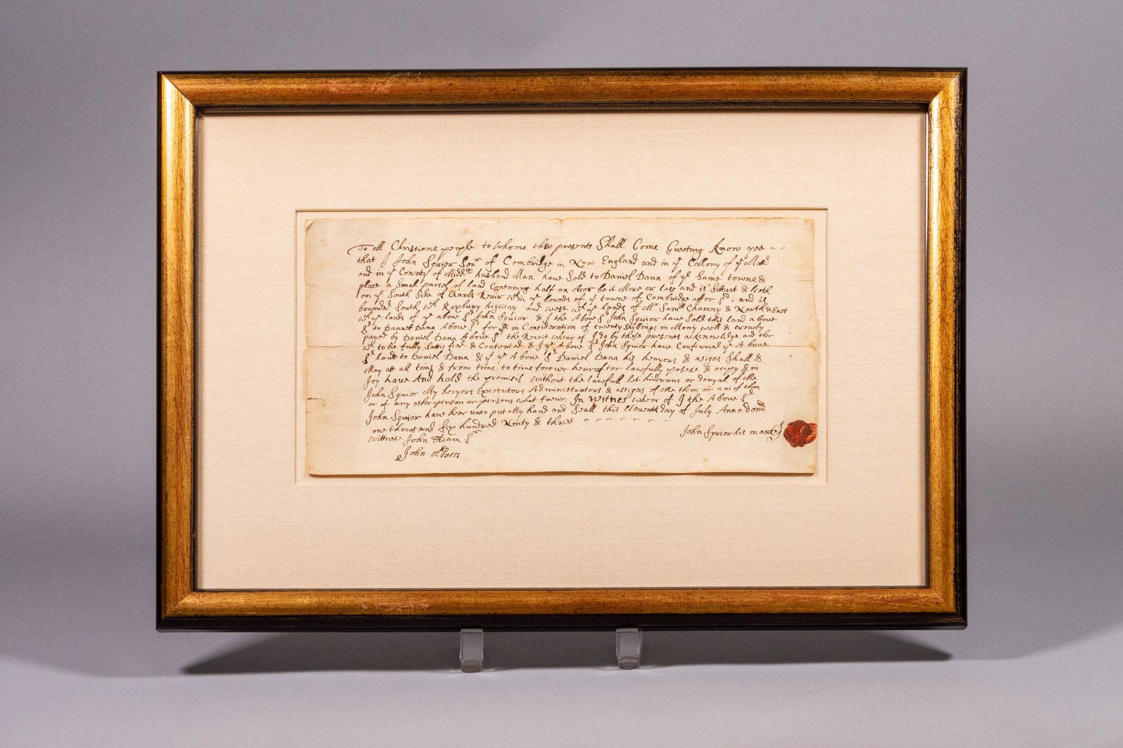 Framed Historical Land Contact, Cambridge,: Framed and matted handwritten land contract for a property in Cambridge, Massachusetts, dated July 11, 1693, signed in pen and with a wax seal. MEASUREMENTS: 18.5" x 13" in frame. 11.75" x 6" for just